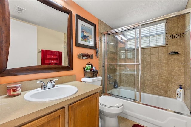 full bathroom with a textured ceiling, vanity, toilet, and enclosed tub / shower combo