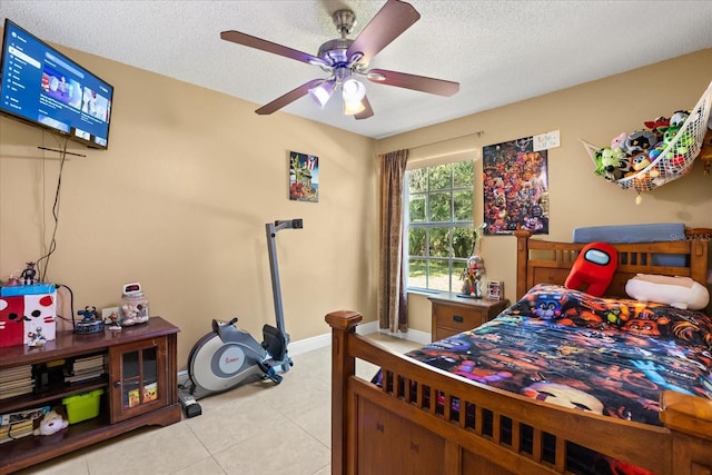 tiled bedroom with ceiling fan and a textured ceiling