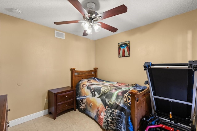 tiled bedroom featuring a textured ceiling and ceiling fan