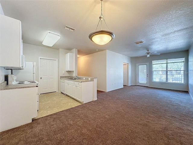 kitchen with white appliances, light colored carpet, ceiling fan, sink, and white cabinetry