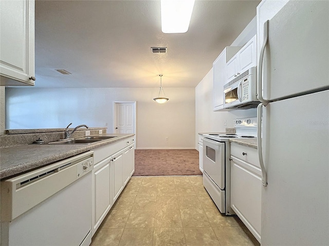 kitchen featuring light carpet, white appliances, sink, white cabinets, and hanging light fixtures