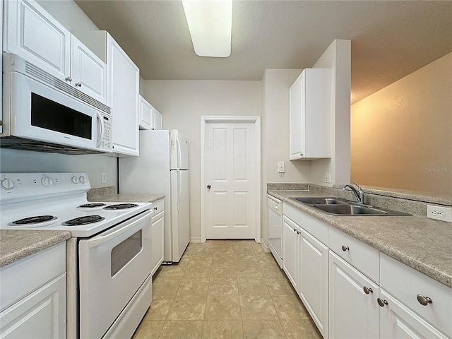 kitchen featuring light tile patterned floors, white appliances, white cabinetry, and sink