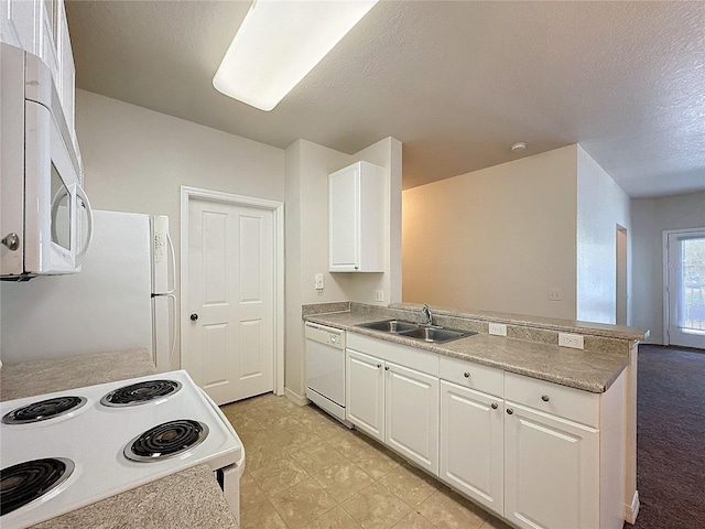 kitchen with sink, kitchen peninsula, a textured ceiling, white appliances, and white cabinets