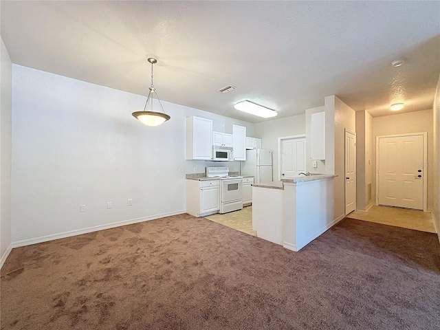 kitchen featuring pendant lighting, white appliances, light carpet, white cabinetry, and kitchen peninsula