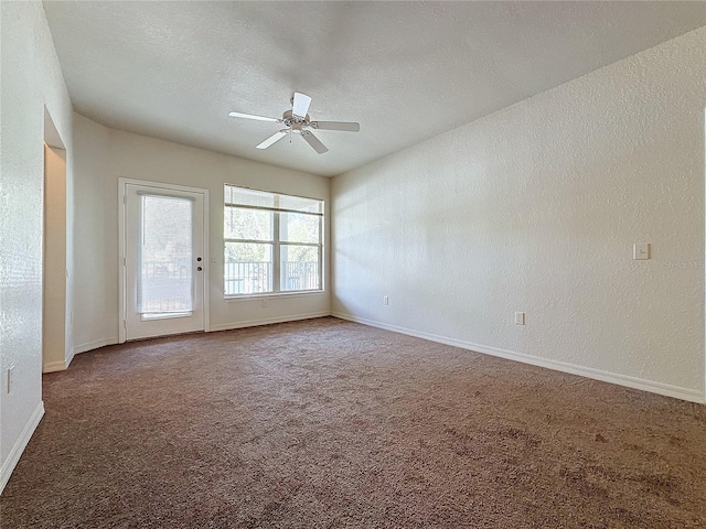 spare room featuring carpet, a textured ceiling, and ceiling fan