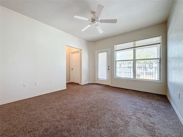 carpeted empty room featuring ceiling fan