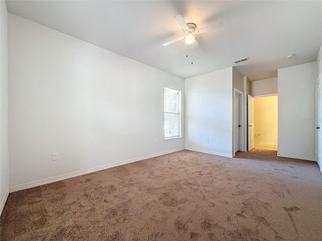 spare room with ceiling fan and carpet