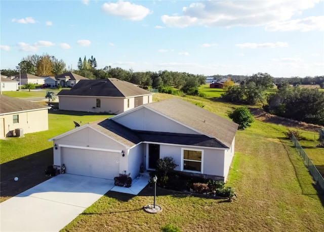 326 Dinner Lake Ct, Lake Wales, FL 33859 - ranch-style home with an attached garage, driveway, a front yard, and stucco siding