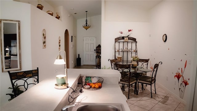 dining room with vaulted ceiling and light tile patterned flooring