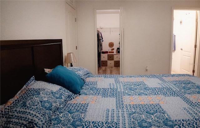 bedroom featuring wood-type flooring and connected bathroom