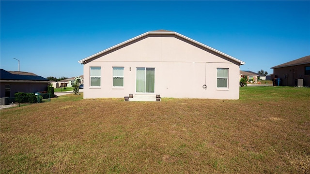 back of house with a lawn