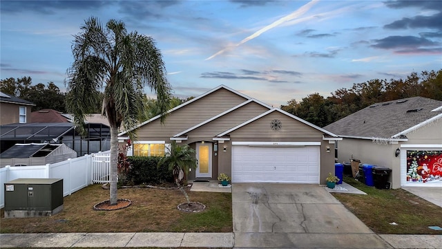 view of front of home with a yard and a garage