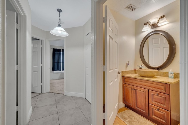 bathroom with tile patterned floors and vanity