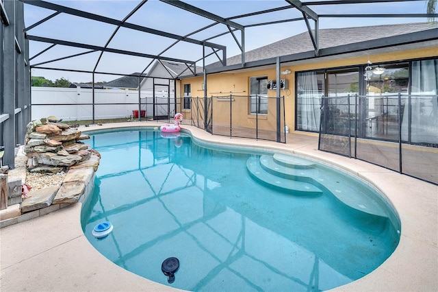 view of pool featuring a patio area and glass enclosure