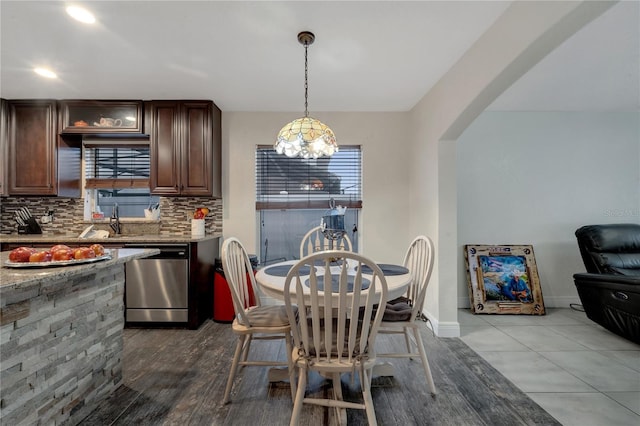 dining space with light hardwood / wood-style floors and sink