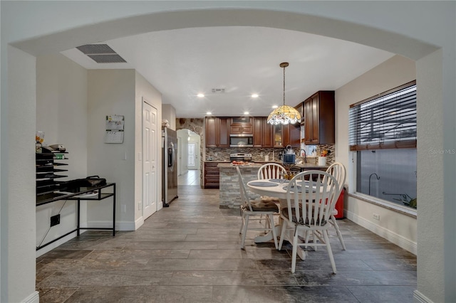 dining area featuring hardwood / wood-style flooring and sink