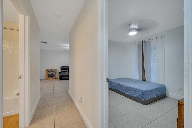 tiled bedroom featuring ceiling fan