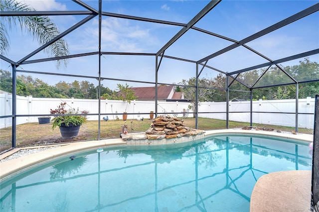 view of pool featuring glass enclosure