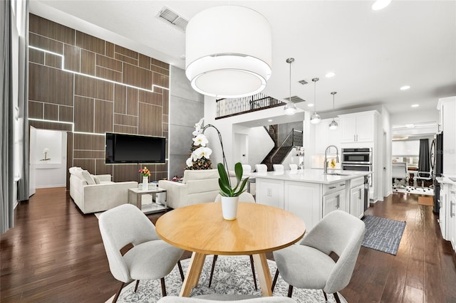 dining space featuring dark hardwood / wood-style flooring and sink