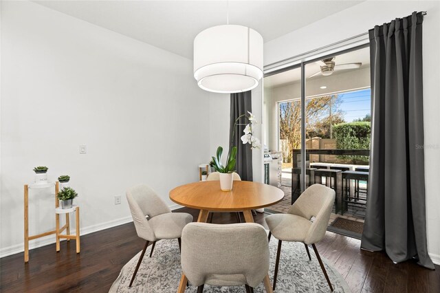 dining area featuring ceiling fan and dark hardwood / wood-style flooring