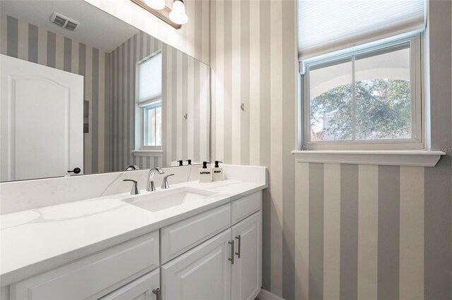 bathroom featuring plenty of natural light and vanity