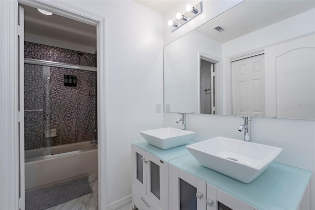 bathroom with shower / bath combination with glass door and vanity