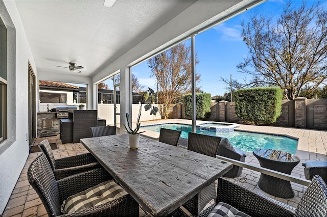 exterior space with a pool with hot tub, an outdoor kitchen, grilling area, and ceiling fan