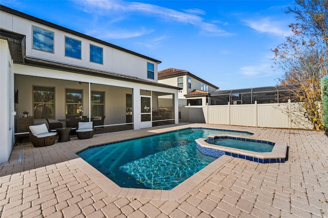 view of pool featuring an in ground hot tub, an outdoor hangout area, a patio area, and a sunroom