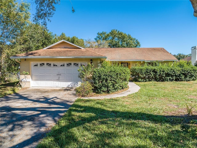 ranch-style house featuring a front yard and a garage