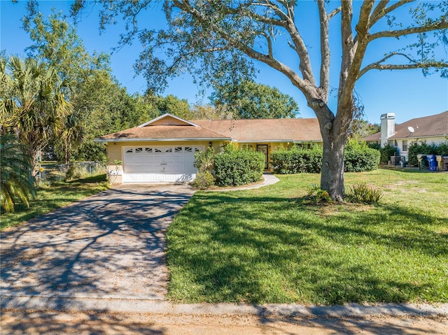 ranch-style house featuring a front lawn and a garage