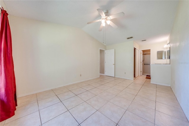 tiled spare room featuring ceiling fan and lofted ceiling