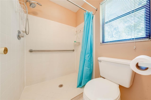 bathroom with a shower with curtain and toilet