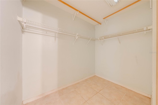 spacious closet featuring tile patterned flooring