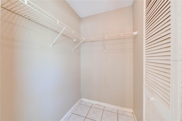 walk in closet featuring light tile patterned flooring