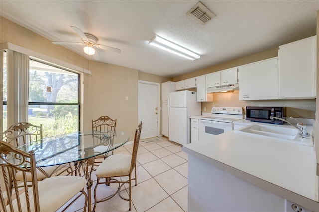 kitchen featuring white appliances, white cabinets, sink, ceiling fan, and a textured ceiling