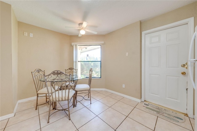 dining space with ceiling fan and light tile patterned floors