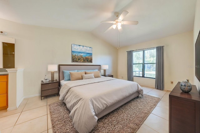 tiled bedroom with ceiling fan and vaulted ceiling