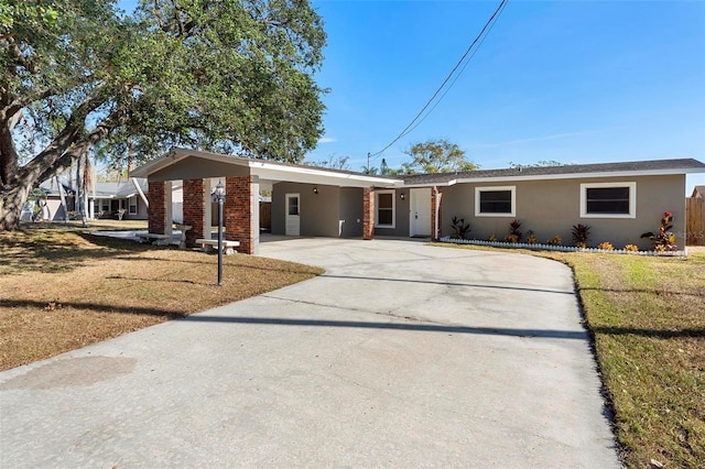 ranch-style home with a front yard and a carport