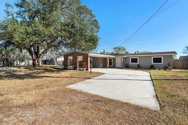 back of house with a lawn and a carport