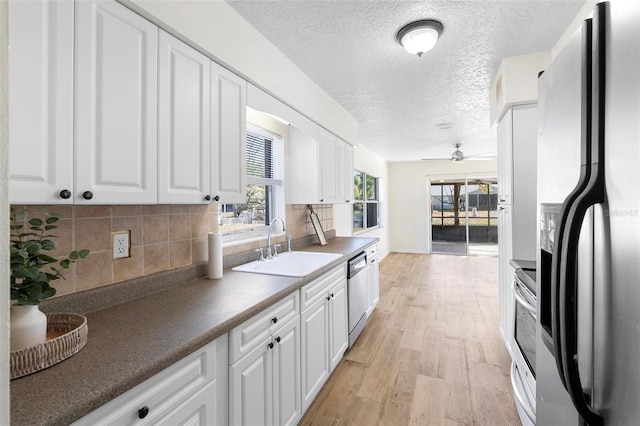 kitchen featuring ceiling fan, white cabinets, light hardwood / wood-style floors, and appliances with stainless steel finishes