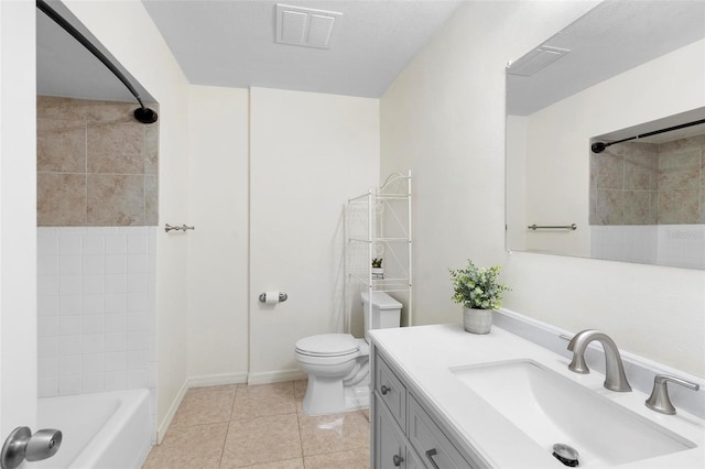 full bathroom featuring tiled shower / bath, tile patterned flooring, vanity, and toilet