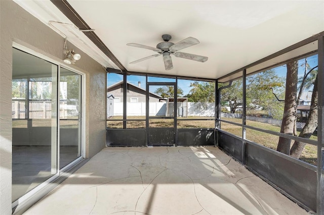 unfurnished sunroom with a wealth of natural light and ceiling fan