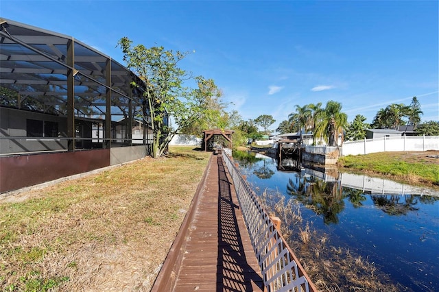 dock area featuring a lanai and a water view