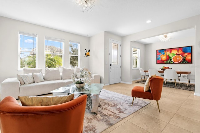 tiled living room featuring a chandelier