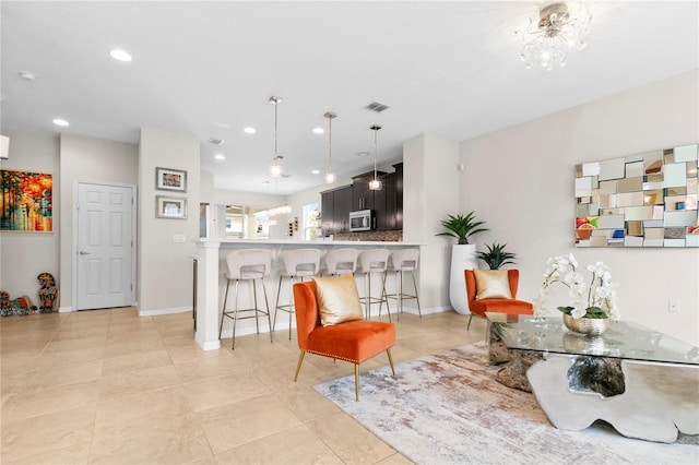 kitchen featuring kitchen peninsula, a kitchen breakfast bar, and light tile patterned floors