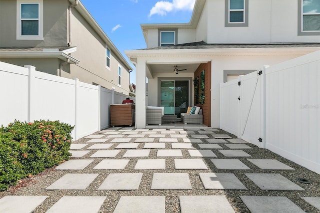 view of exterior entry featuring a patio area and ceiling fan