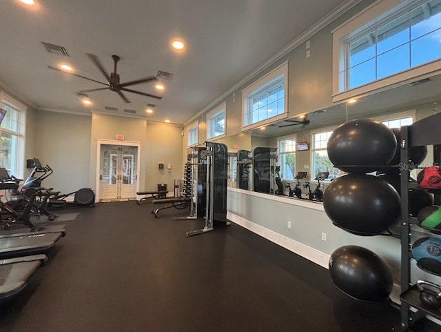 gym featuring ceiling fan, a healthy amount of sunlight, and crown molding