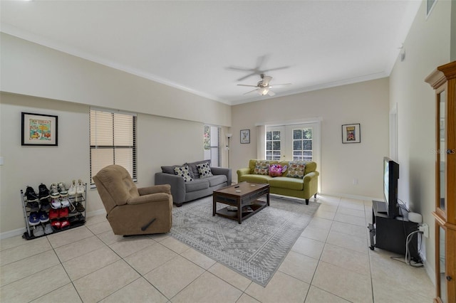 living room with french doors, ceiling fan, crown molding, and light tile patterned flooring