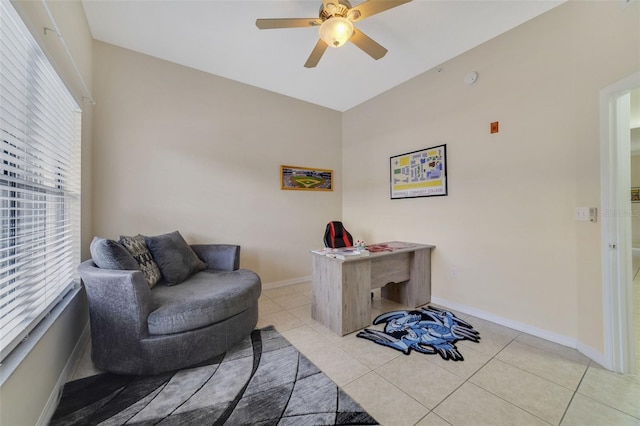 living area featuring ceiling fan and light tile patterned flooring