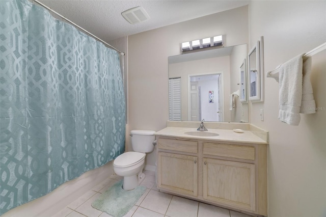 full bathroom featuring tile patterned flooring, shower / bath combination with curtain, a textured ceiling, toilet, and vanity